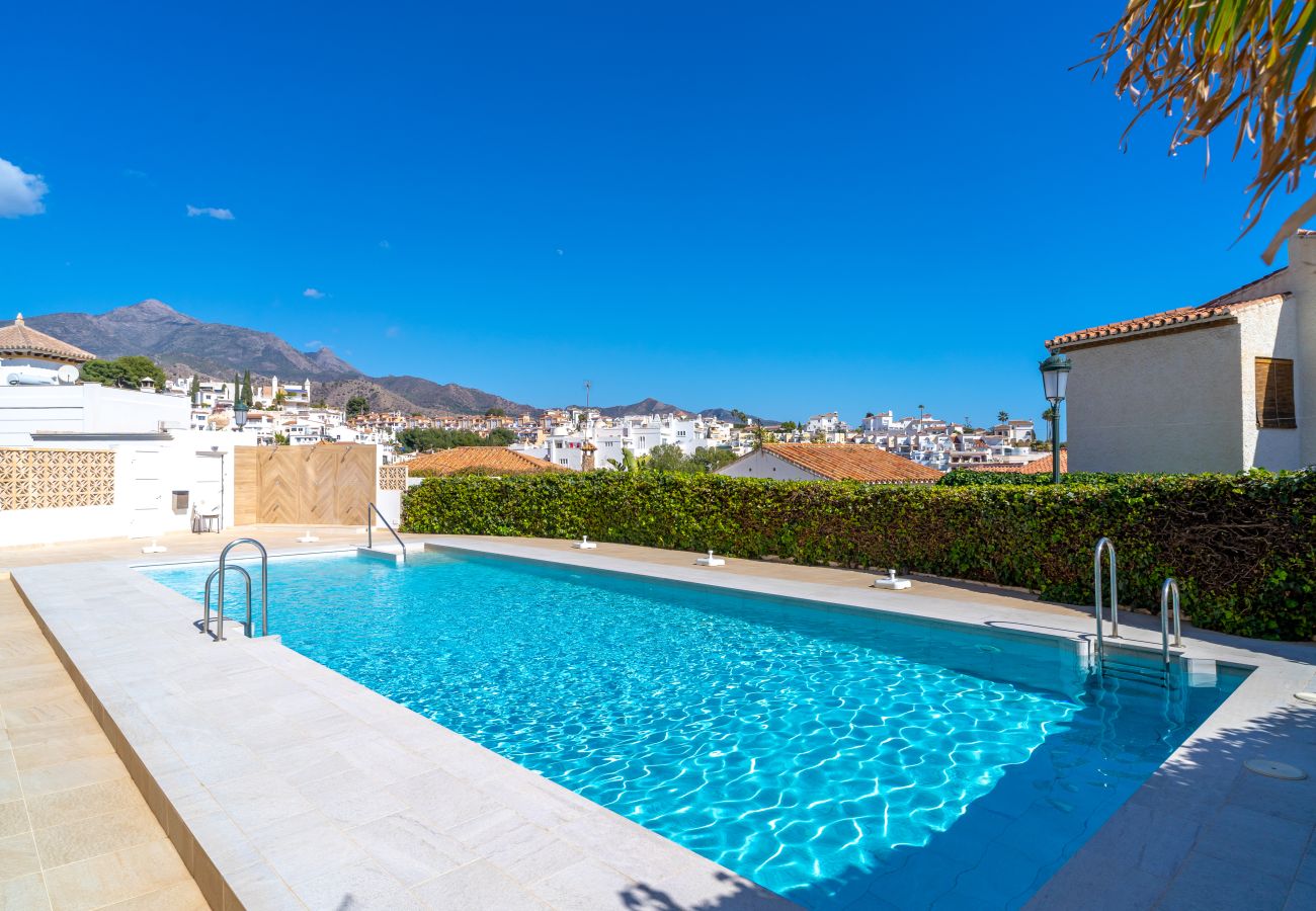 Outdoor pool with crystal-clear water at Miami 44 Seaview Apartment in Nerja, perfect for a relaxing holiday